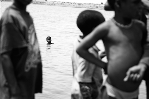 January: Young Boy Swimming in River Giuseppe Aquili